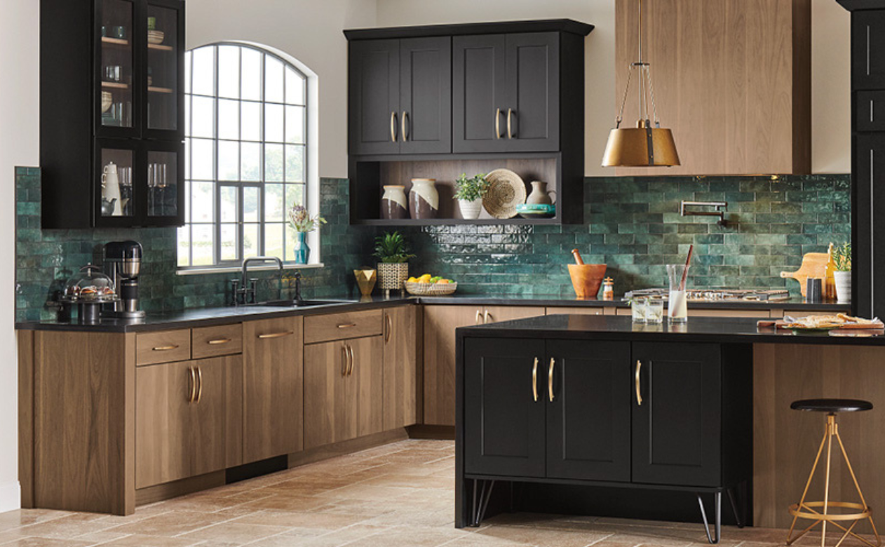 Emerald green tile backsplash in a kitchen with brown and black cabinetry
